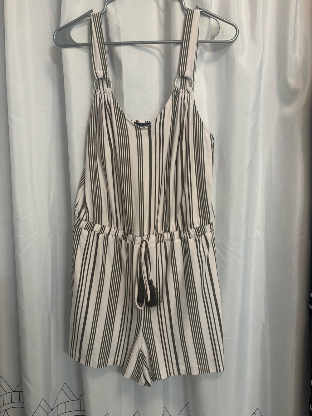 Derek Heart stripped beige and khaki romper with front tassels .